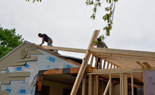 The first of the upper rafters goes in.