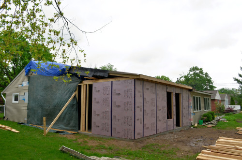 Protecting the new construction from rain.