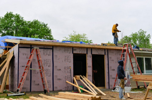 Roof shingling begins.