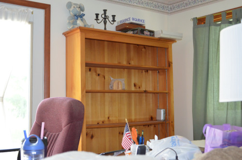 The nearly empty bookcase.