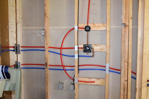 Shower plumbing, with temperature control on the bottom and diverter above.