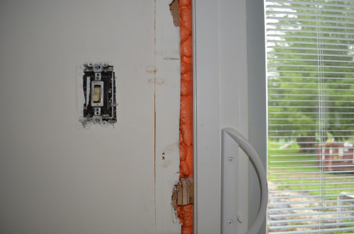 Expanding foam both insulates and secures the slider.