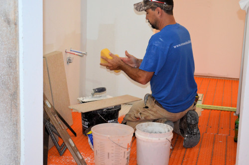 Chad prepares to lay the first tiles.