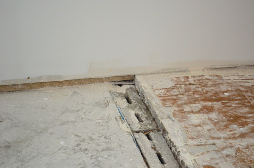 The difference in floor level is about 3/4-inch at the wall.