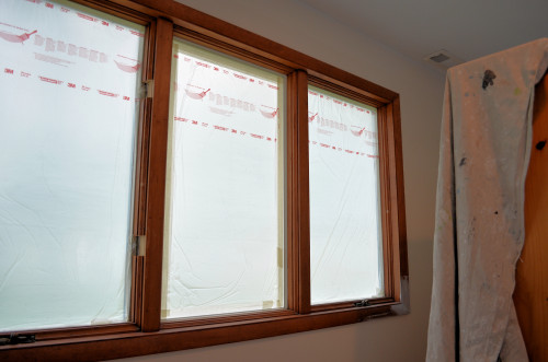 Window trim secured and windows masked for painting.