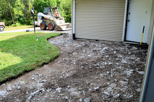 The old, badly cracked front walk is no more.